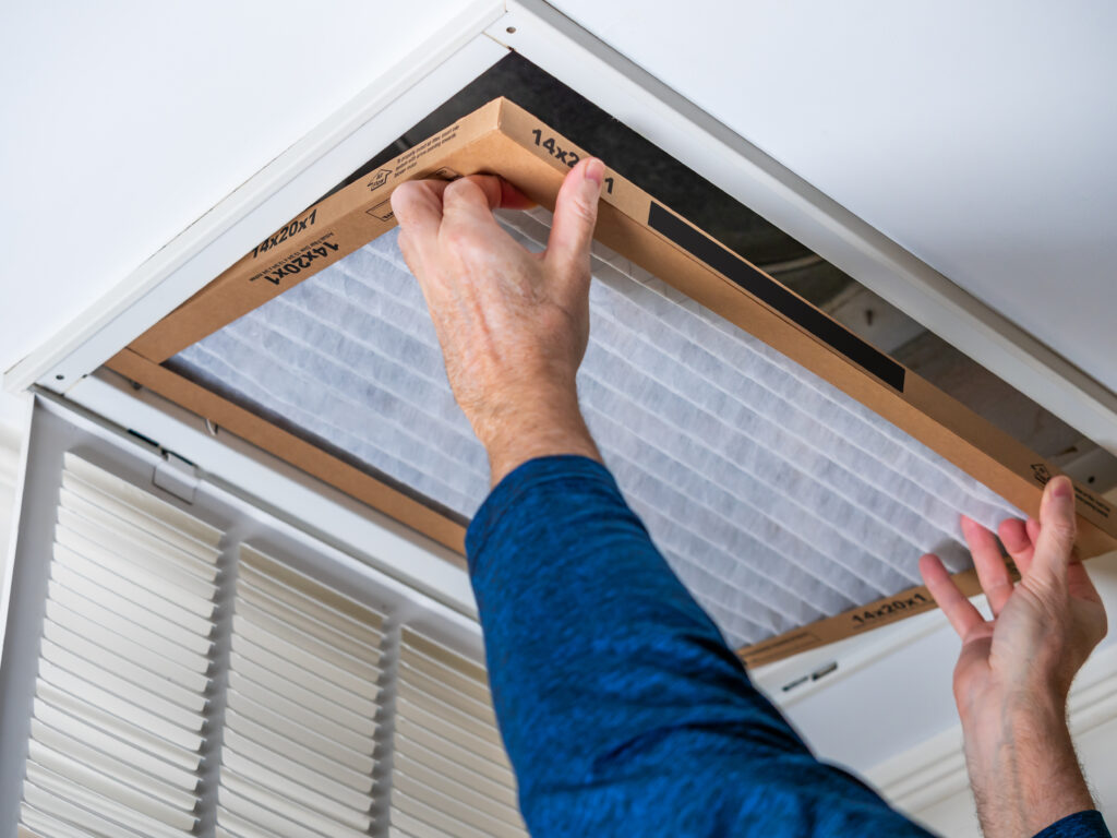 HVAC technician replacing a home air filter in Temple City