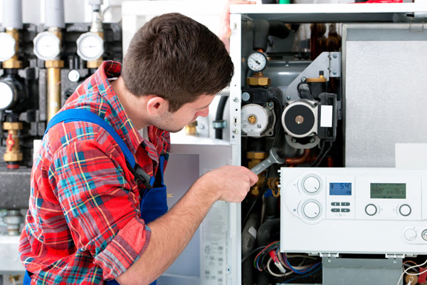 Heating technician repairing boiler controls in Temple City