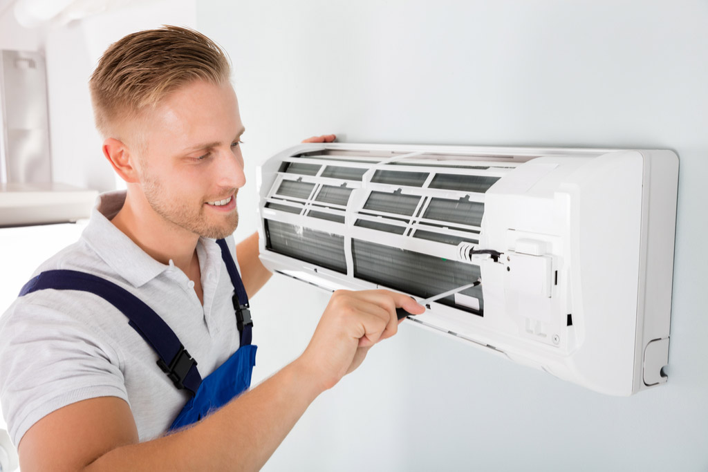 HVAC technician maintaining a ductless air conditioner in Temple City