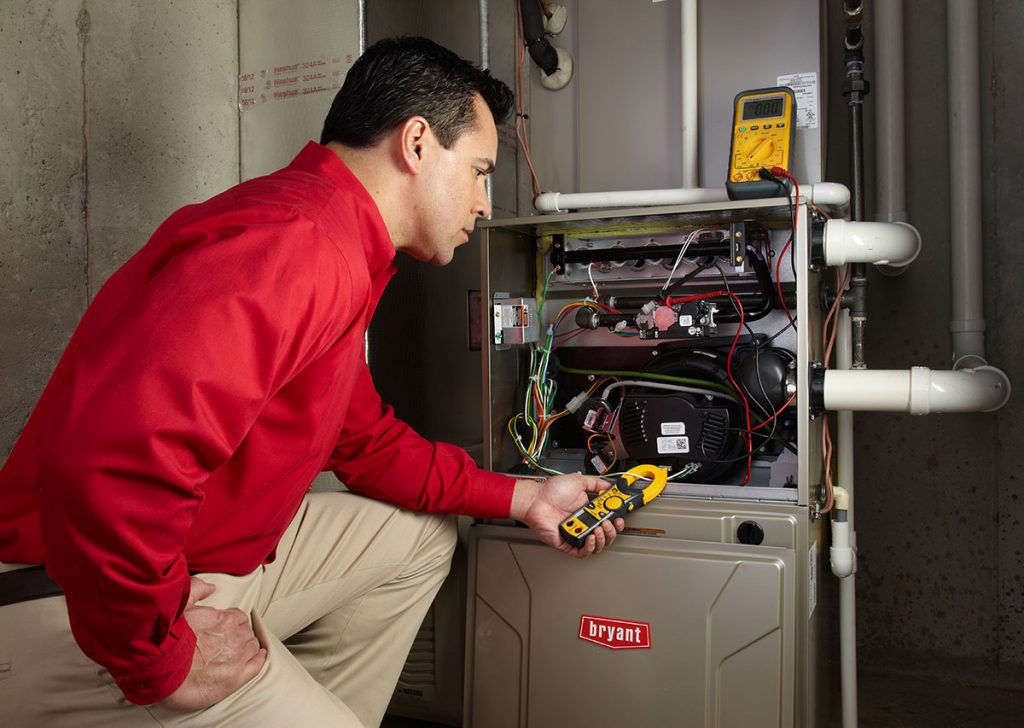Heating technician diagnosing a furnace repair in Temple City