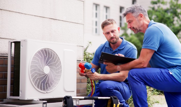 HVAC technicians installing an outdoor air conditioning unit in Temple City