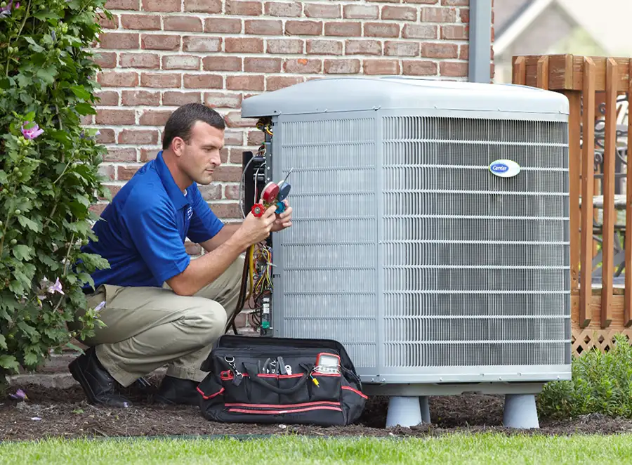 HVAC technician inspecting an outdoor AC unit in Temple City